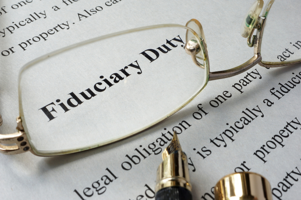 fiduciary duty text with glasses and pen